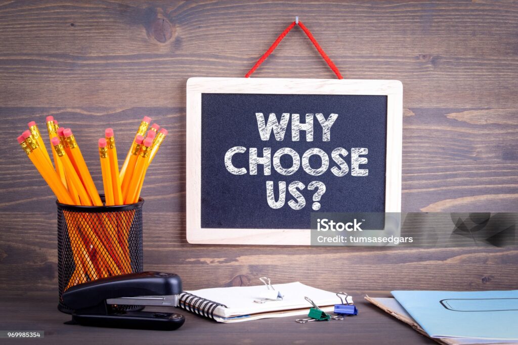 Why choose us? Chalkboard on a wooden background